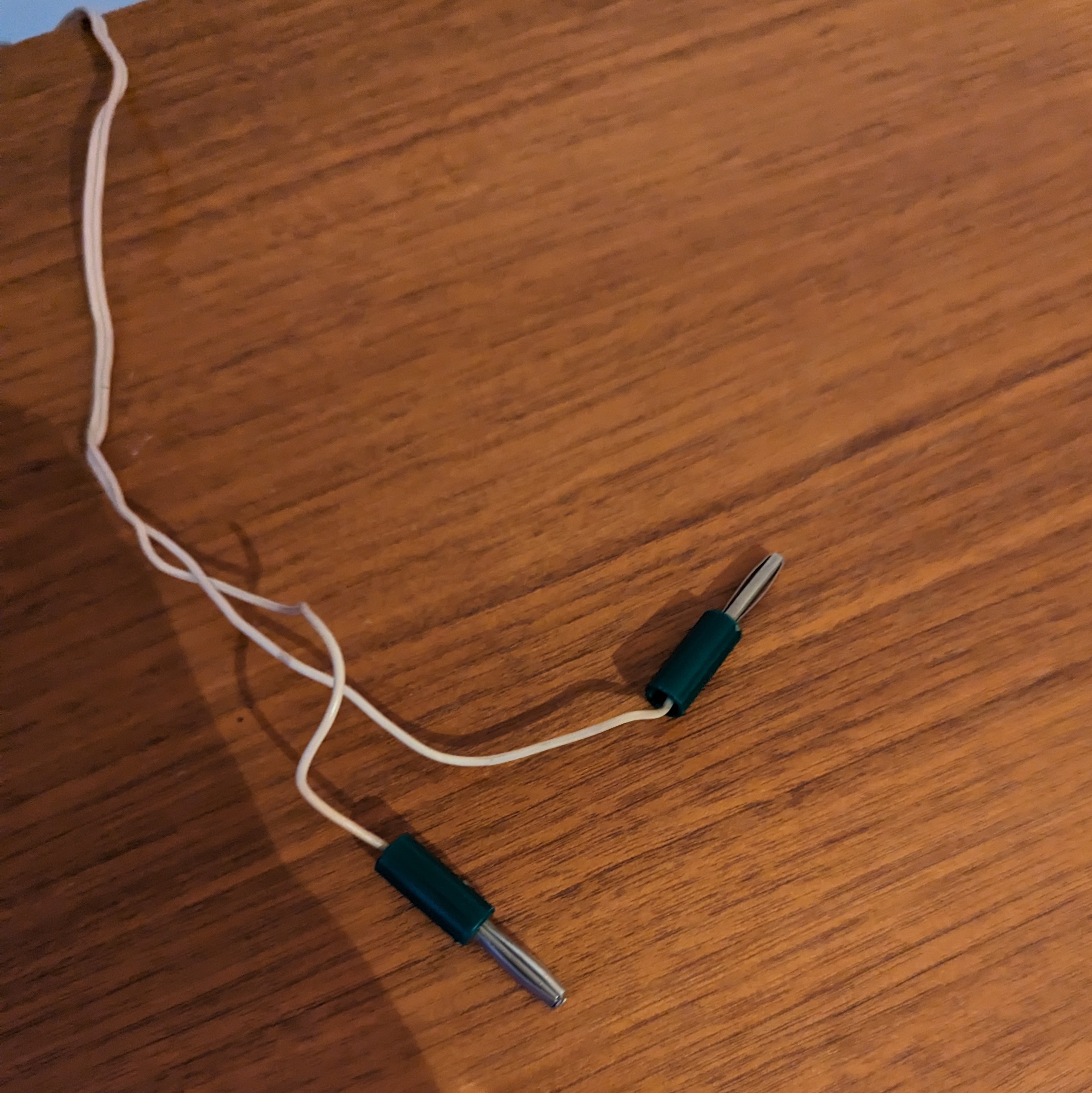Two cables with male banana connectors attached.